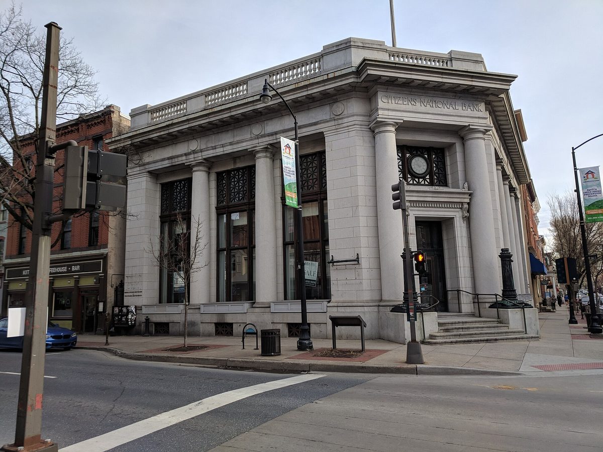 Historic downtown Frederick, Maryland with brick storefronts and a clock tower.